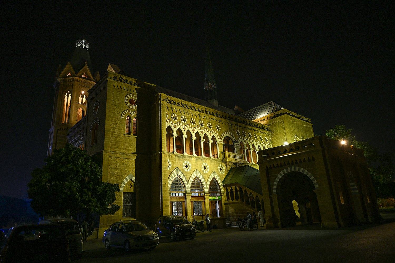 Historic building glowing yellow at night