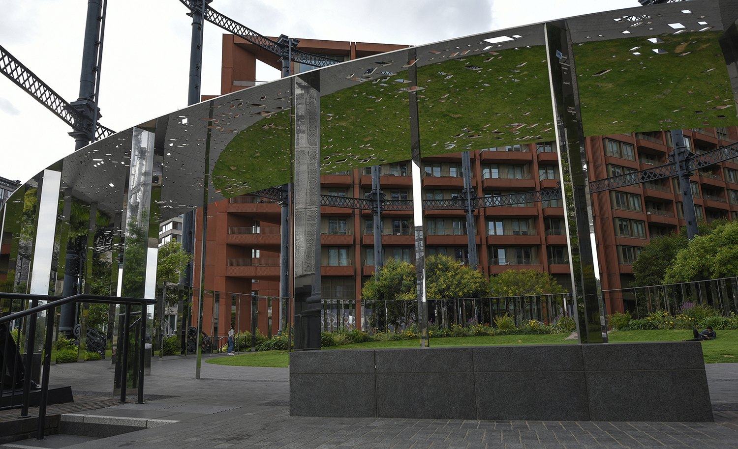 Green roof ring above red brick apartments