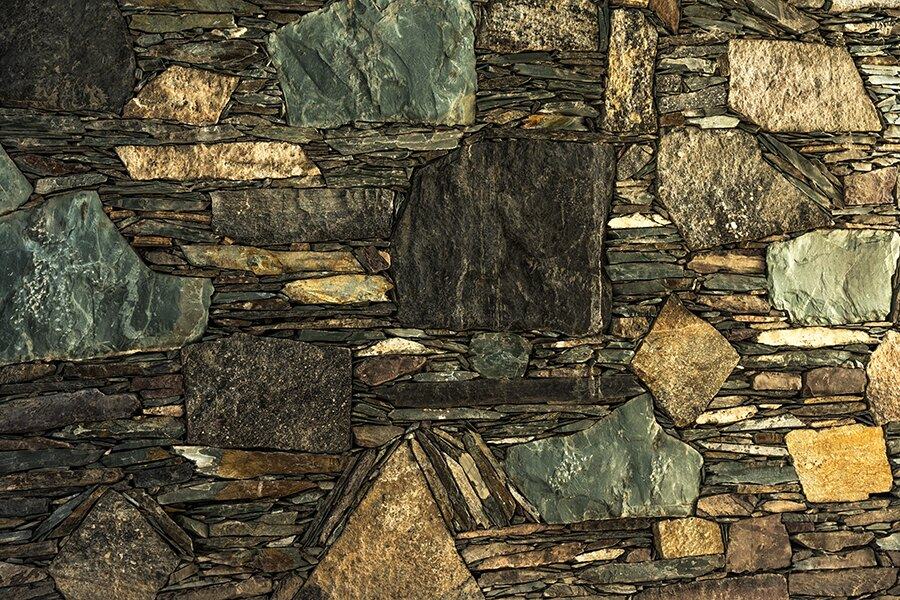 Mixed stone wall in green, gold and grey