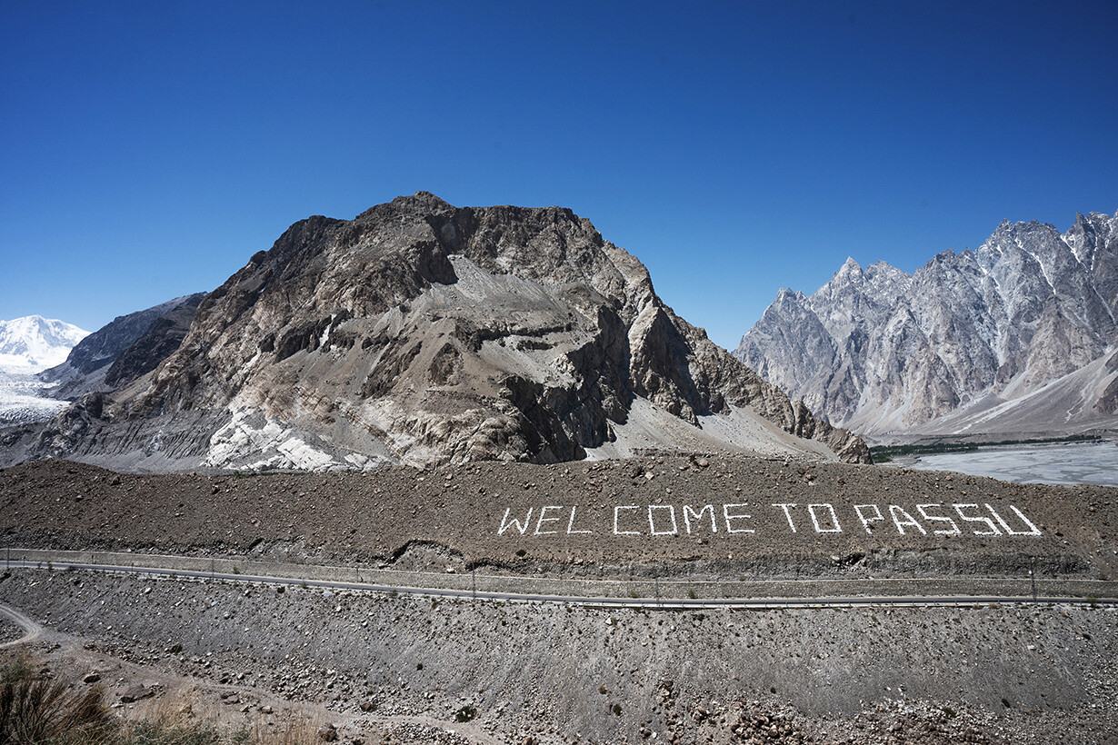 Rugged mountain peaks above a gravel slope near Passu