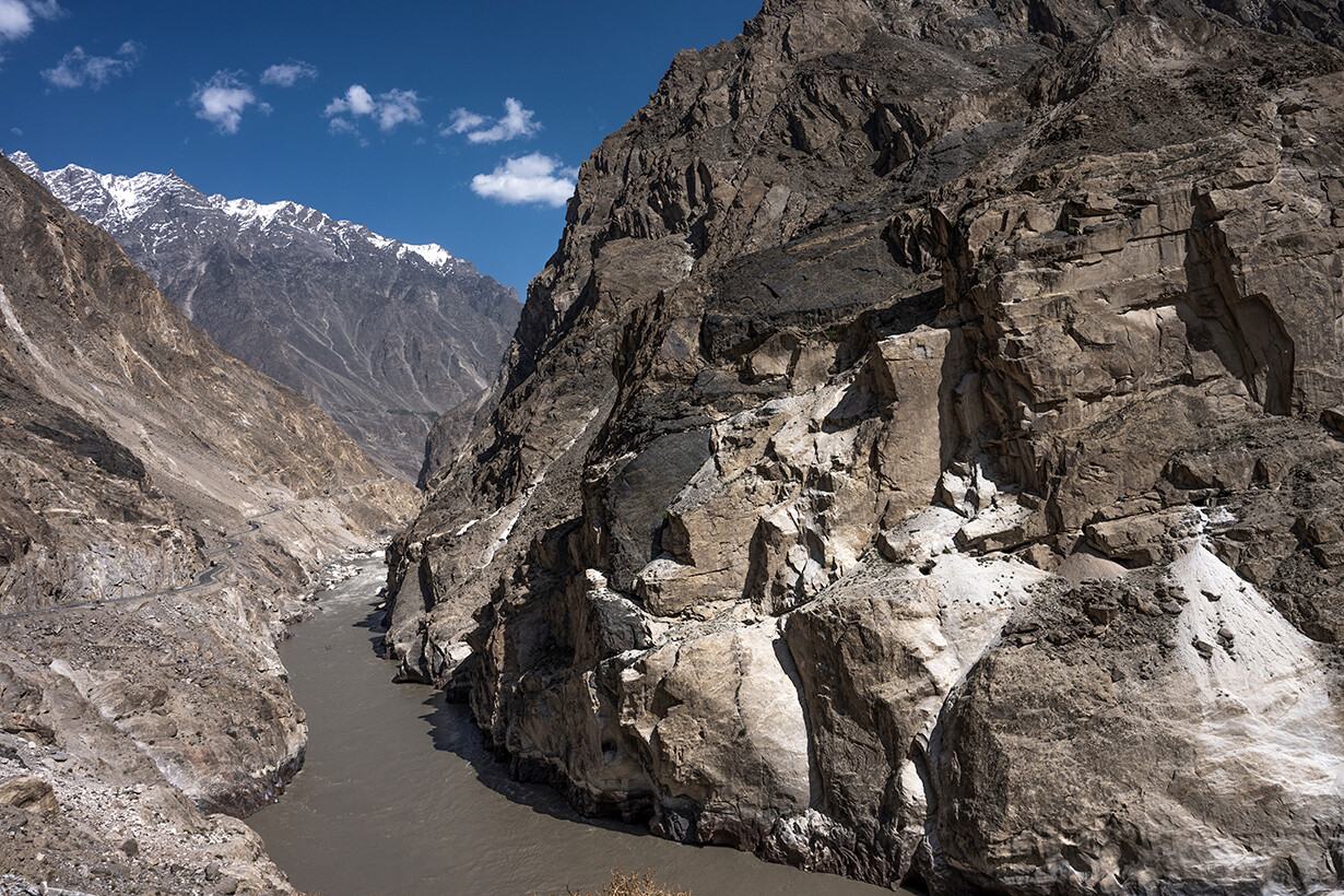 River gorge between tall rock walls and distant snow peaks